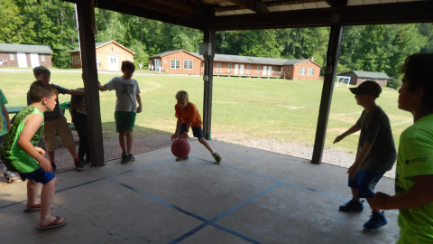 youth engaged in a game of four-square.
